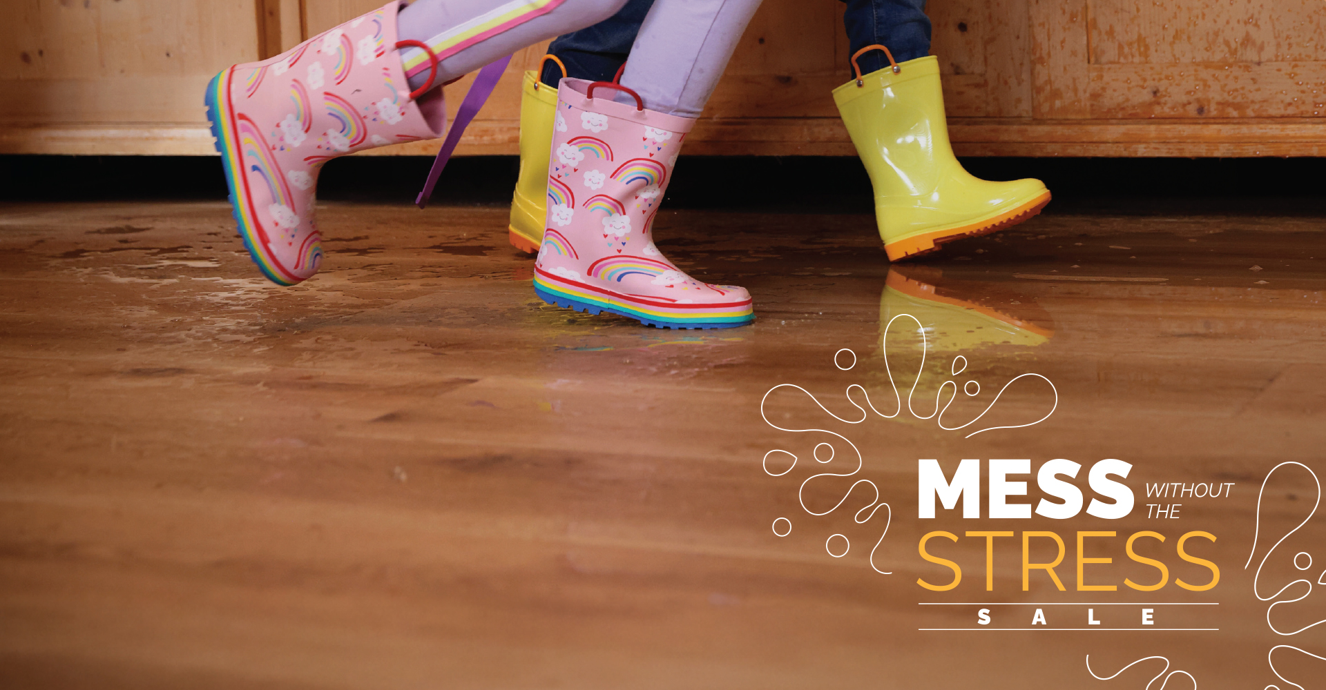 Kids playing in rain boots on luxury vinyl flooring.